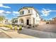 Beautiful two story home with stucco exterior, arched porch entry, manicured landscaping, and brick paved driveway at 2491 N 149Th Ln, Goodyear, AZ 85395