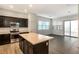 Open-concept kitchen showcasing an island, stainless steel appliances, and a view into the living area at 2491 N 149Th Ln, Goodyear, AZ 85395