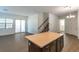 Open-concept living room with tile flooring, sliding doors to the outside, and stairs to the second floor at 2491 N 149Th Ln, Goodyear, AZ 85395