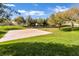Community park featuring a basketball court, grassy areas, mature trees, and volleyball court at 2491 N 149Th Ln, Goodyear, AZ 85395
