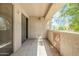 A private tiled balcony with a storage closet, plus a partial view of the landscape at 29606 N Tatum Blvd # 265, Cave Creek, AZ 85331