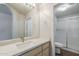 Bathroom with light wood cabinets, quartz countertop, and glass-enclosed shower at 29606 N Tatum Blvd # 265, Cave Creek, AZ 85331