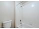 Bathroom featuring a white tiled shower/tub and white toilet at 29606 N Tatum Blvd # 265, Cave Creek, AZ 85331