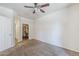 A bright bedroom features neutral carpet, a ceiling fan, and an open door to a walk-in closet at 29606 N Tatum Blvd # 265, Cave Creek, AZ 85331
