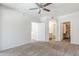 Neutral bedroom with carpet, ceiling fan, and doorways to the bathroom and walk-in closet at 29606 N Tatum Blvd # 265, Cave Creek, AZ 85331