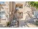Attractive condominium exterior featuring stairs leading to the units and well-maintained landscaping at 29606 N Tatum Blvd # 265, Cave Creek, AZ 85331