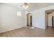 Living room with wood-look floors, arched entry, and ceiling fan at 29606 N Tatum Blvd # 265, Cave Creek, AZ 85331