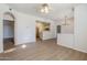 Open concept living area with wood-look floors and a partial view of the kitchen at 29606 N Tatum Blvd # 265, Cave Creek, AZ 85331