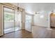Open living area with balcony access, ceiling fan, and kitchen view at 29606 N Tatum Blvd # 265, Cave Creek, AZ 85331