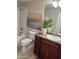 Bathroom featuring wood cabinets, sink, toilet, tub, and art at 29606 N Tatum Blvd # 276, Cave Creek, AZ 85331