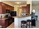 Charming kitchen with breakfast bar, black appliances, and ample cabinet space at 29606 N Tatum Blvd # 276, Cave Creek, AZ 85331