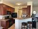 Charming kitchen with breakfast bar, black appliances, and ample cabinet space at 29606 N Tatum Blvd # 276, Cave Creek, AZ 85331