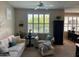 Inviting living room with large window, ceiling fan, and adjacent dining area at 29606 N Tatum Blvd # 276, Cave Creek, AZ 85331