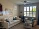 Cozy living room with plantation shutters, comfortable seating, and a ceiling fan at 29606 N Tatum Blvd # 276, Cave Creek, AZ 85331