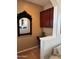 Office nook area with elegant mirror and stained wood cabinet space at 29606 N Tatum Blvd # 276, Cave Creek, AZ 85331