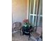 Relaxing patio featuring two chairs, a round table, and flowers for a serene retreat at 29606 N Tatum Blvd # 276, Cave Creek, AZ 85331
