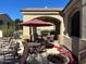 Charming pool area offering a serene ambiance with umbrella-shaded seating and garden accents at 29606 N Tatum Blvd # 276, Cave Creek, AZ 85331