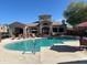 Community pool featuring a spacious deck with lounge chairs and a covered lounge area for residents at 29606 N Tatum Blvd # 276, Cave Creek, AZ 85331