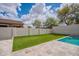 Backyard featuring artificial grass, in-ground pool, and stone tile at 2969 E Trigger Way, Gilbert, AZ 85297