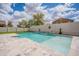 Beautiful in-ground pool with waterfall and artificial grass in backyard at 2969 E Trigger Way, Gilbert, AZ 85297
