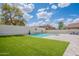 Backyard area featuring an in-ground pool, lawn, and fenced yard at 2969 E Trigger Way, Gilbert, AZ 85297
