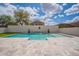Stunning backyard pool with a waterfall feature and manicured landscaping at 2969 E Trigger Way, Gilbert, AZ 85297