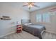 Comfortable bedroom with bright window, neutral paint, and stylish finishes at 2969 E Trigger Way, Gilbert, AZ 85297