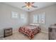 Cozy bedroom with lots of natural light, ceiling fan, carpet flooring, and white plantation shutters at 2969 E Trigger Way, Gilbert, AZ 85297