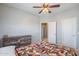 Comfortable bedroom featuring ceiling fan, carpet flooring, and paneled doors at 2969 E Trigger Way, Gilbert, AZ 85297