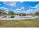 Large pond in a community park with trees, sidewalks and a gazebo on an island at 2969 E Trigger Way, Gilbert, AZ 85297
