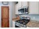A kitchen appliance with granite countertops and stainless steel gas range at 2969 E Trigger Way, Gilbert, AZ 85297