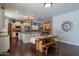 Bright eat-in kitchen featuring stainless steel appliances, large island, and dark hardwood floors at 2969 E Trigger Way, Gilbert, AZ 85297