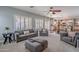 Open-concept living room with recessed lighting, plantation shutters, and seamless transition into kitchen at 2969 E Trigger Way, Gilbert, AZ 85297