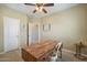Office with neutral walls and carpet featuring rustic wood desk and modern light fixture at 2969 E Trigger Way, Gilbert, AZ 85297