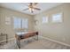Office with neutral walls and carpet featuring wood desk, modern light fixture, and plantation shutters at 2969 E Trigger Way, Gilbert, AZ 85297