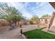 Backyard area featuring stone decorations, a wooden fence, and artificial grass at 29972 N Bryce Trl, San Tan Valley, AZ 85144