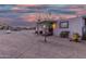 Charming single-story home with a covered porch, set against a beautiful desert sunset sky at 29972 N Bryce Trl, San Tan Valley, AZ 85144