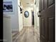 Inviting hallway with modern flooring, neutral walls, and a decorative mirror at 29972 N Bryce Trl, San Tan Valley, AZ 85144
