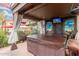 Outdoor hot tub area with covered patio, landscaping, and mural wall art at 29972 N Bryce Trl, San Tan Valley, AZ 85144
