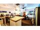 Open-concept living space with kitchen, dining, and bedroom areas, featuring multiple ceiling fans and tile flooring at 29972 N Bryce Trl, San Tan Valley, AZ 85144