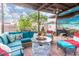 Charming outdoor patio boasts a stone fire pit, plush seating, mural, and a cozy ambiance at 29972 N Bryce Trl, San Tan Valley, AZ 85144