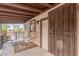 Cozy covered porch with outdoor seating, a decorative rug, and secure gate, perfect for relaxation at 29972 N Bryce Trl, San Tan Valley, AZ 85144