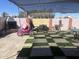 Beautiful backyard with comfortable seating, fireplace, princess carriage and checkered artificial grass at 3020 N 64Th Dr, Phoenix, AZ 85033