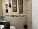 Modern bathroom with decorative backsplash, artistic wall hangings, tile floor and mosaic tile accents at 3020 N 64Th Dr, Phoenix, AZ 85033