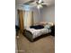 A bedroom featuring a bed with colorful pillows, complemented by neutral-toned curtains at 3020 N 64Th Dr, Phoenix, AZ 85033