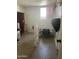 Simple bedroom with a window, bed frame and evidence of possible damage to a section of the wall at 3020 N 64Th Dr, Phoenix, AZ 85033