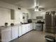 Bright kitchen features stainless steel appliances, white cabinetry and a clean tile floor at 3020 N 64Th Dr, Phoenix, AZ 85033