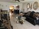 The Living room offers comfortable couches with gold accents, tiled flooring and gold decorative mirrors at 3020 N 64Th Dr, Phoenix, AZ 85033