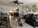 The Living room offers comfortable couches with gold accents, tiled flooring and gold decorative mirrors at 3020 N 64Th Dr, Phoenix, AZ 85033