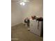 A functional utility room featuring a washer and dryer, essential for laundry needs at 3020 N 64Th Dr, Phoenix, AZ 85033